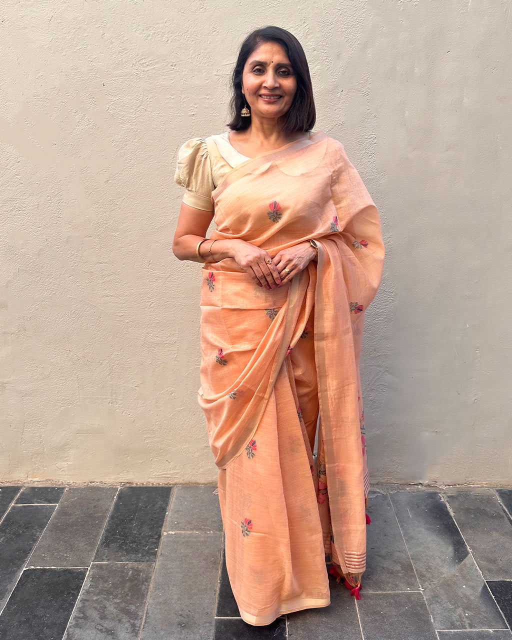 Elegant Peach Tussar Silk Saree by Rajathee Saree with a geometric influenced border and floral print.