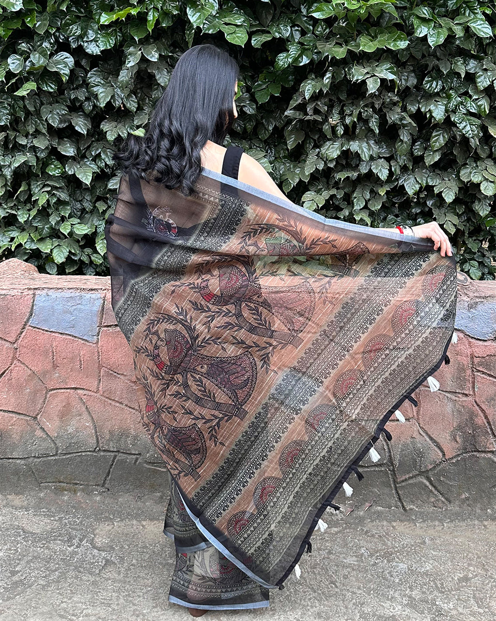 Elegant back view of Rajathee Saree Black Cotton Super Net showing the detailed peacock motifs and sheer lightweight drape.