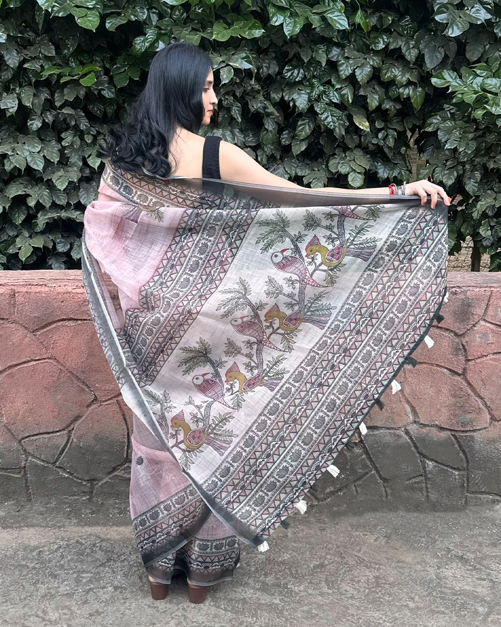 Graceful back view of the lightweight Rajathee Saree in Black and Pink Cotton Super Net with a fluid drape.