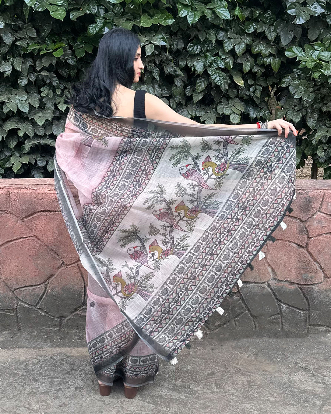 Graceful back view of the lightweight Rajathee Saree in Black and Pink Cotton Super Net with a fluid drape.