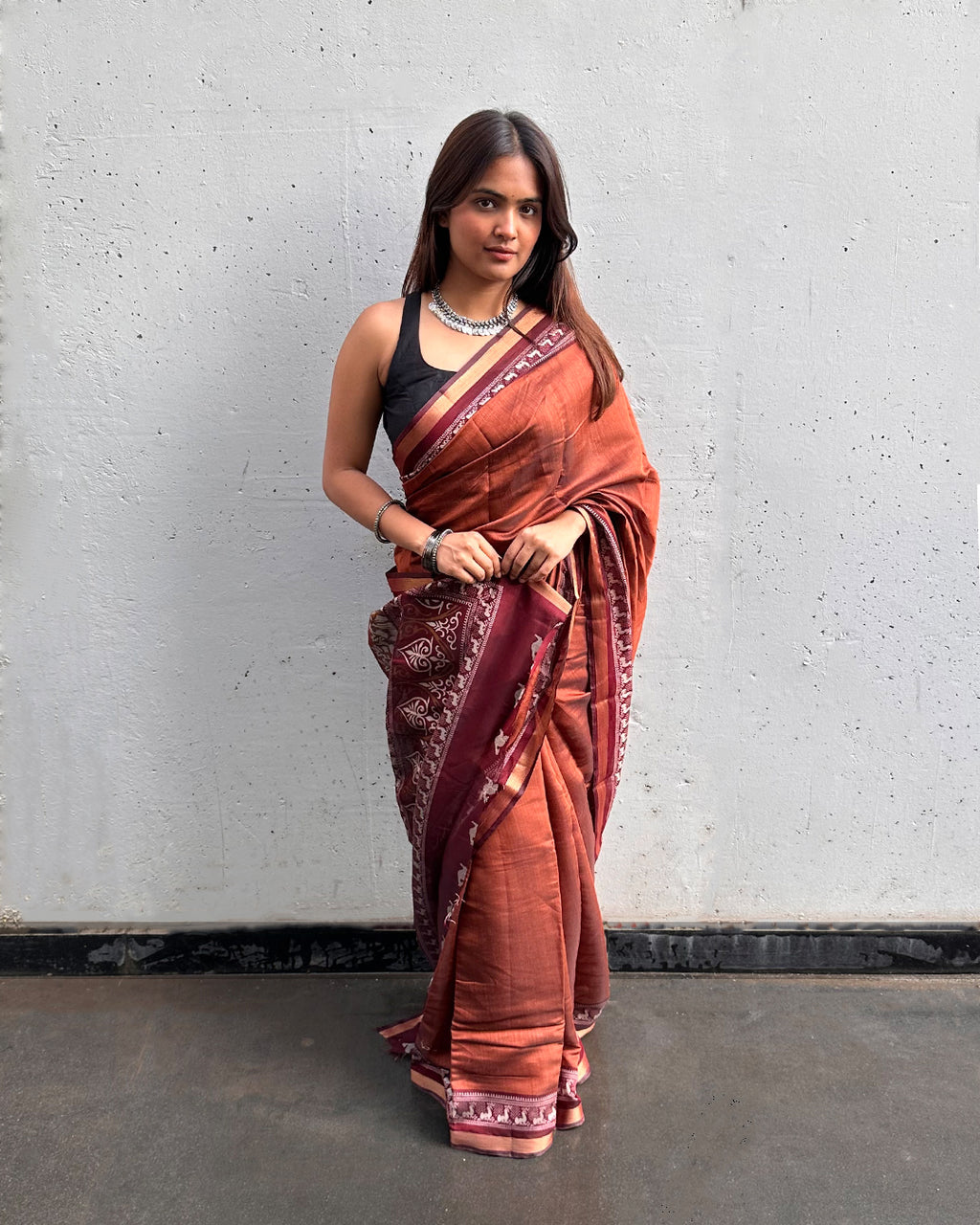 Deep Maroon Cambric Silk Saree by Rajathee Saree showcasing intricate peacock-inspired prints and a smooth finish.