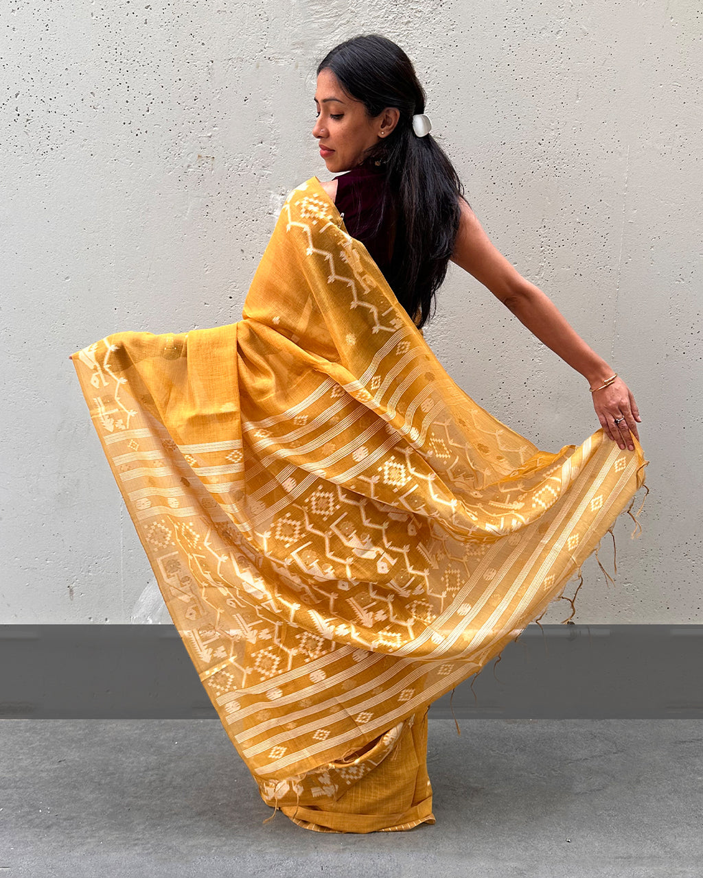 Back view of the Mustard Yellow Tussar Silk Saree by Rajathee Saree showing the elegant geometric pallu.