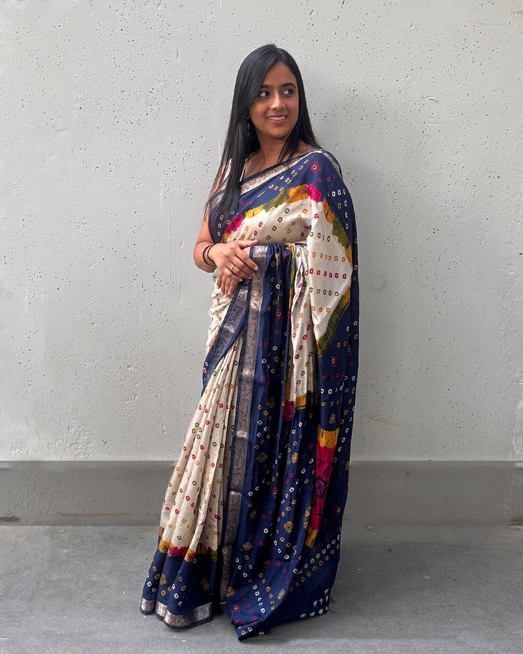 Rajathee Saree Ivory and Blue Cambric Silk Saree featuring a traditional Bandhani print and soft sheen.