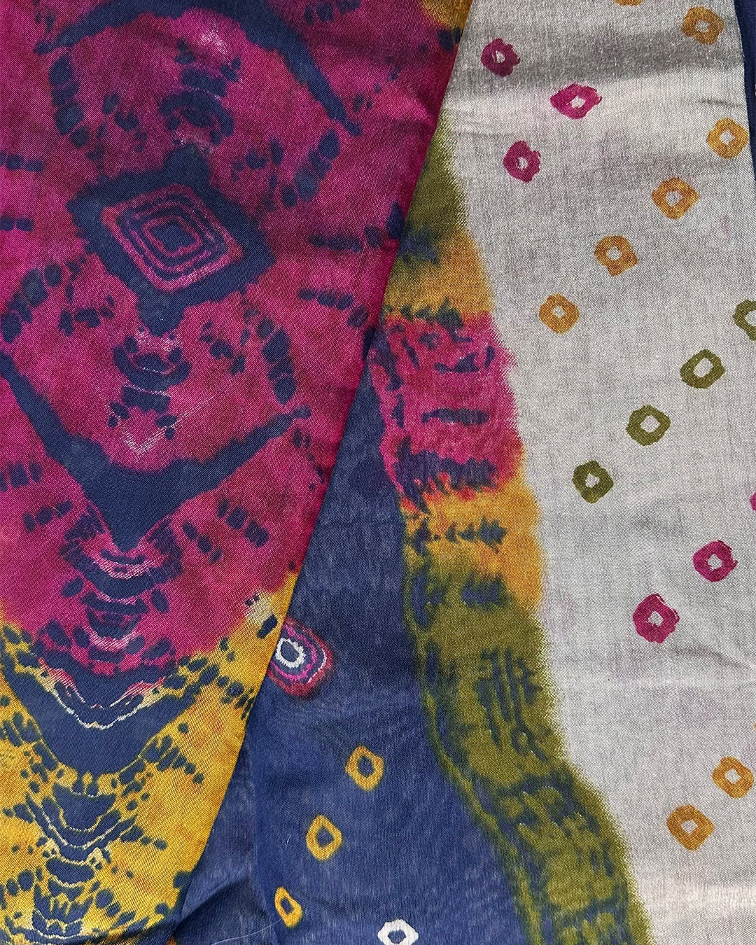 Close-up of the detailed Bandhani print on Ivory and Blue Cambric Silk fabric with vibrant multicolour accents.