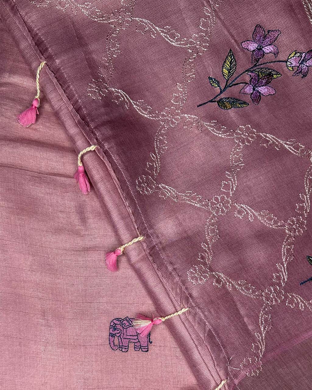 Close-up of the intricate elephant embroidery and tassel accents on the Blush Pink Cotton Silk Rajathee Saree.