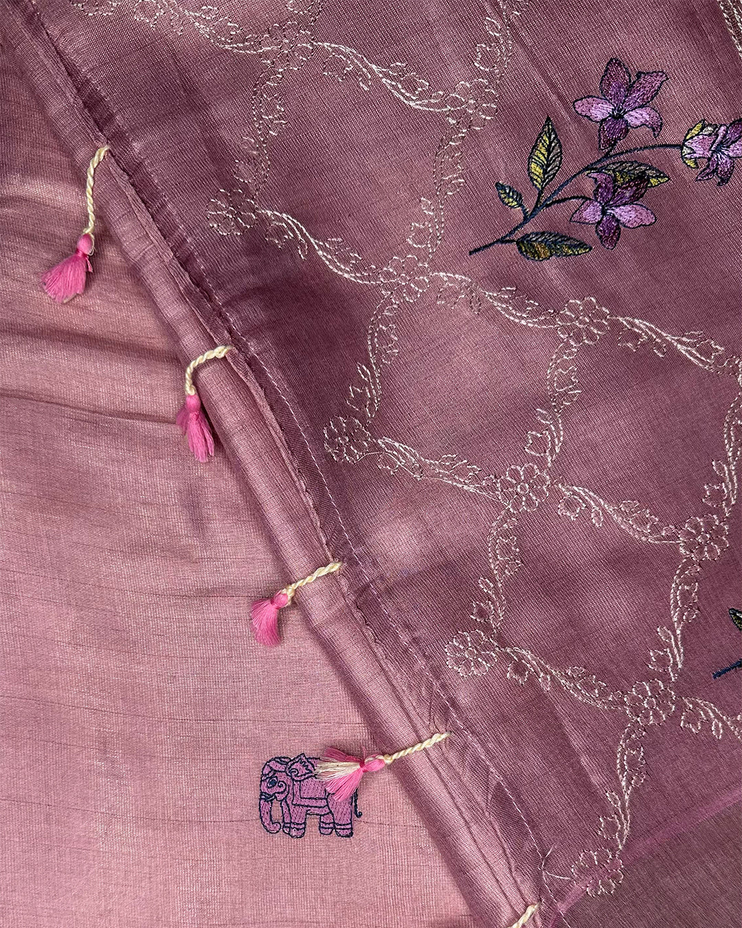 Close-up of the intricate elephant embroidery and tassel accents on the Blush Pink Cotton Silk Rajathee Saree.