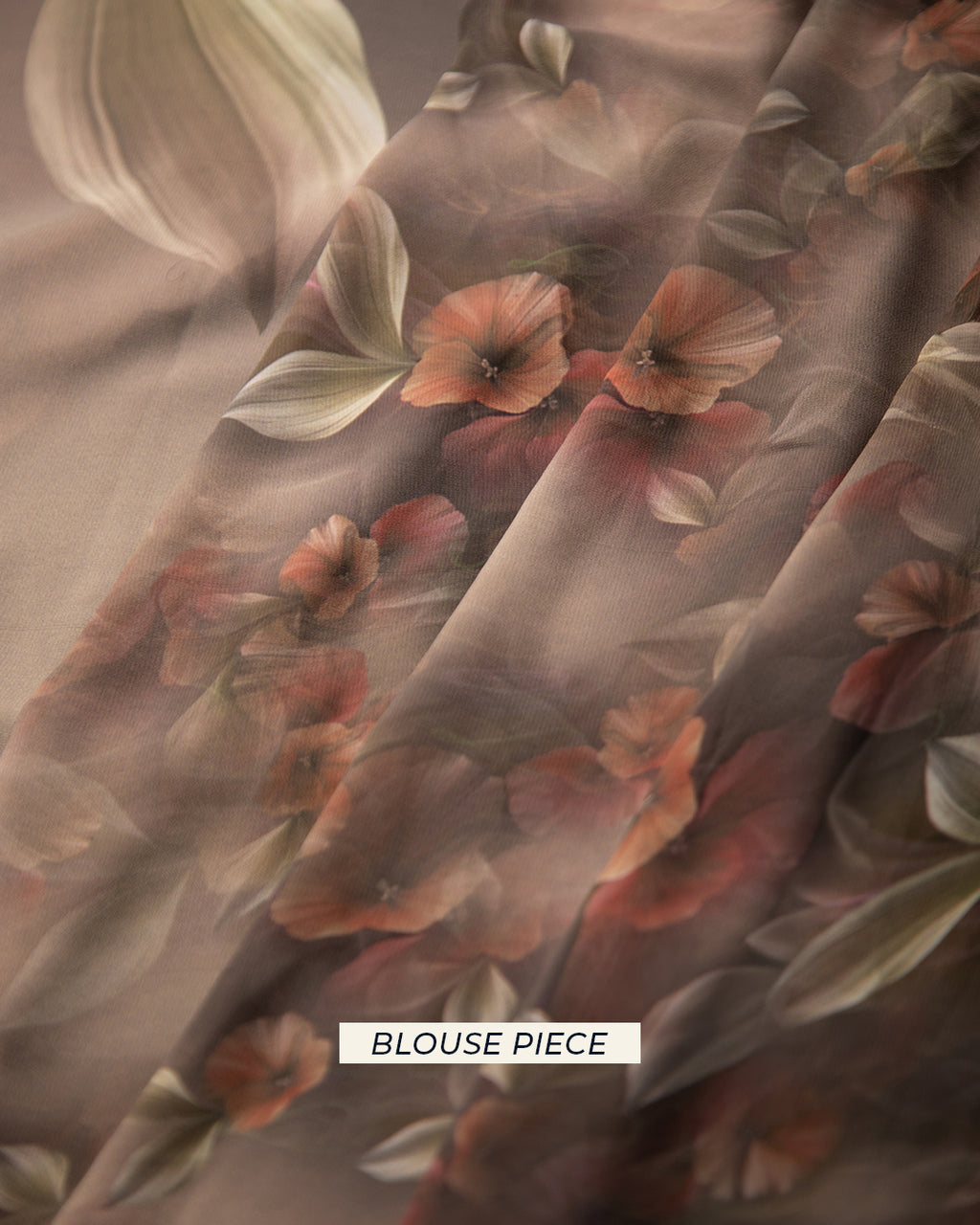 Matching dark grey unstitched blouse piece fabric with small, vibrant rust-toned floral prints for the Rajathee Saree collection.