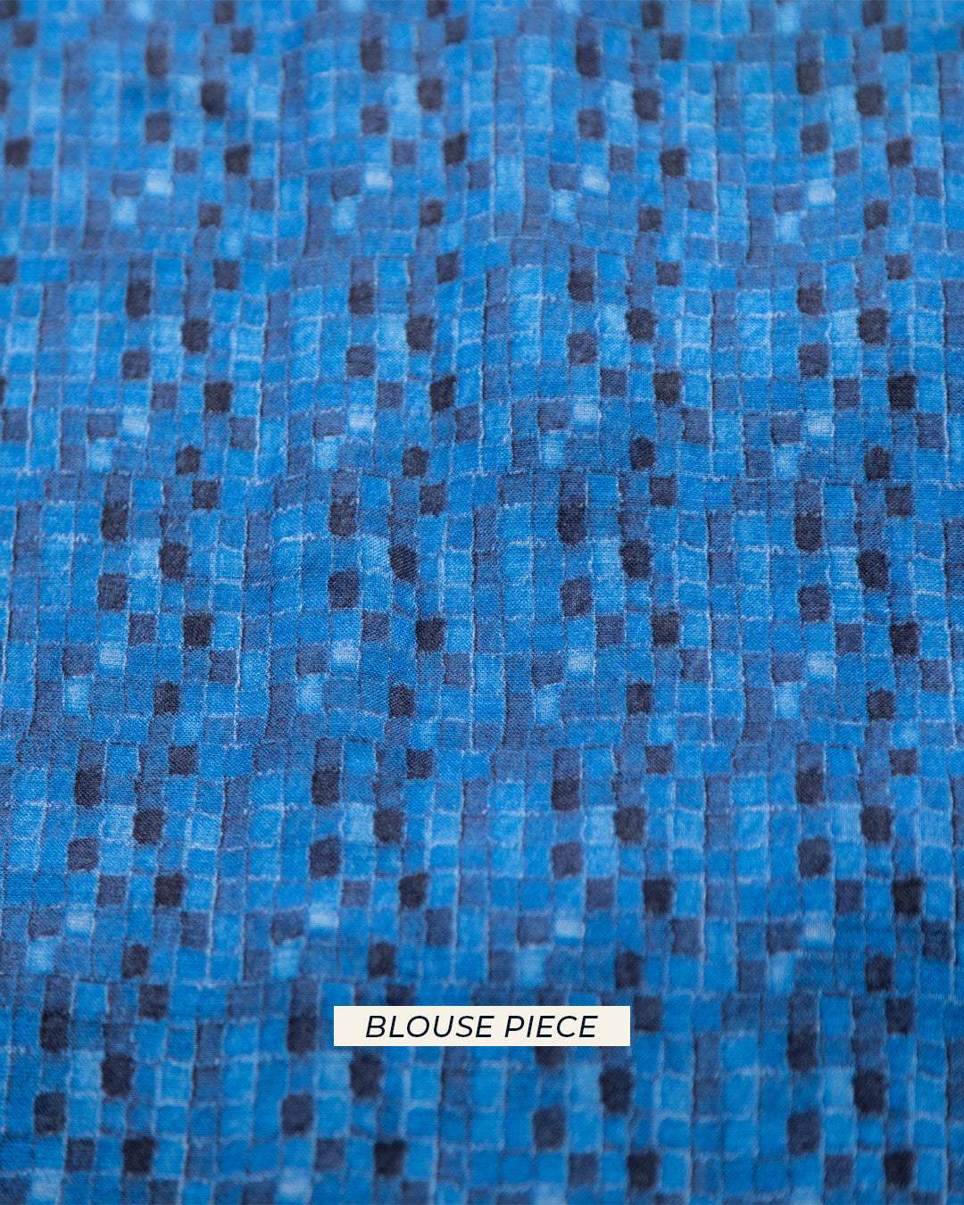 A top-down view of the matching blue blouse piece featuring a modern geometric pattern to complement the denim-inspired saree.