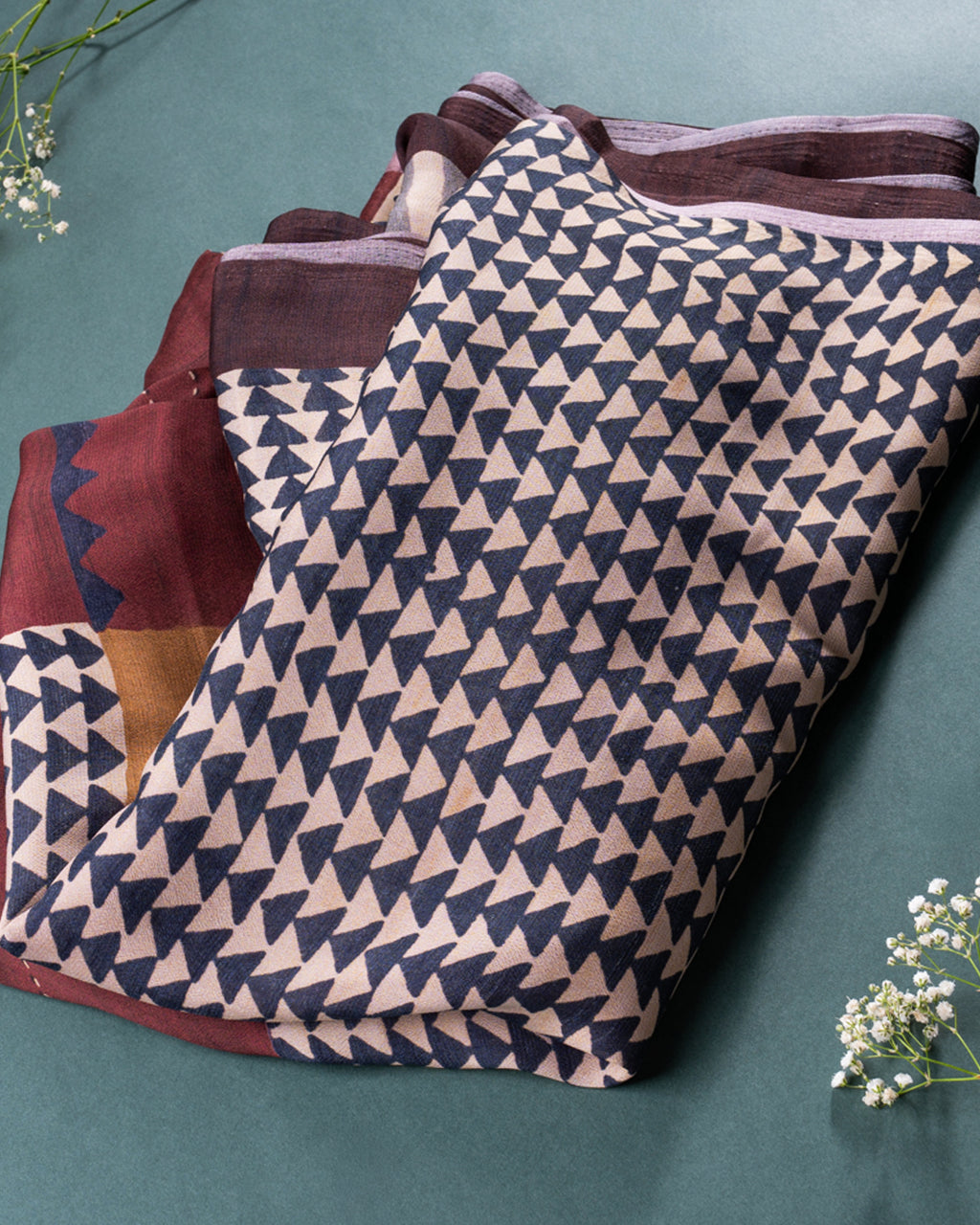 Showcase of the modern patterned pallu and deep rust accents on the Olive Silk Georgette Saree.