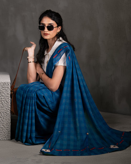 Elegant seated view of the Blue Mul Cotton Saree by Rajathee Saree showcasing its soft, breathable, and lightweight drape.