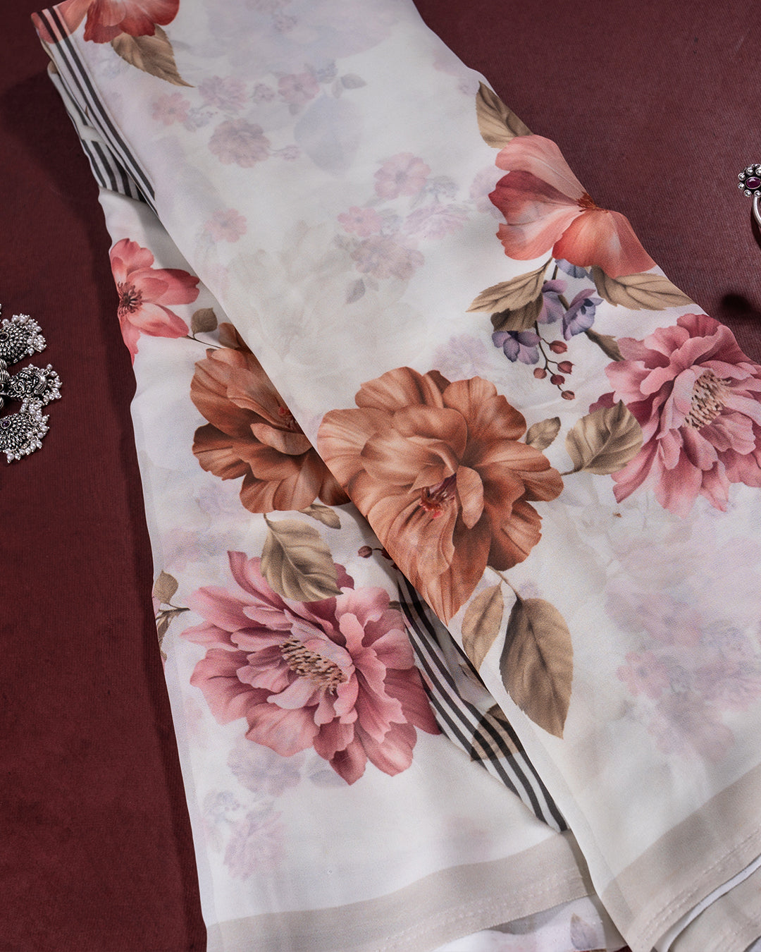 Close-up of the vibrant peach and terracotta floral motifs on the premium Off White Candle Silk fabric.
