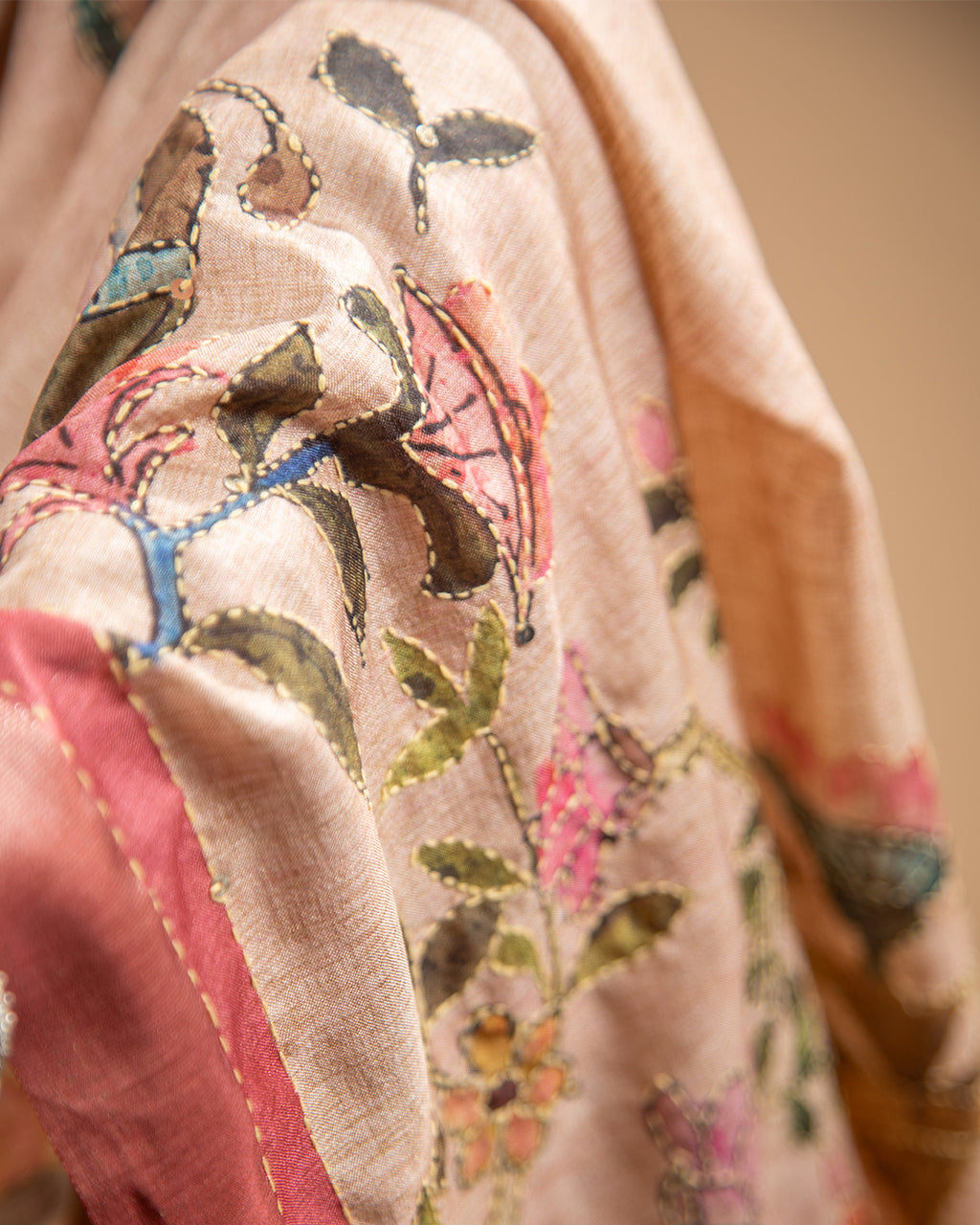 Close-up of the delicate floral and bird motifs on the botanical narrative print of the Blush Pink Rajathee Saree.