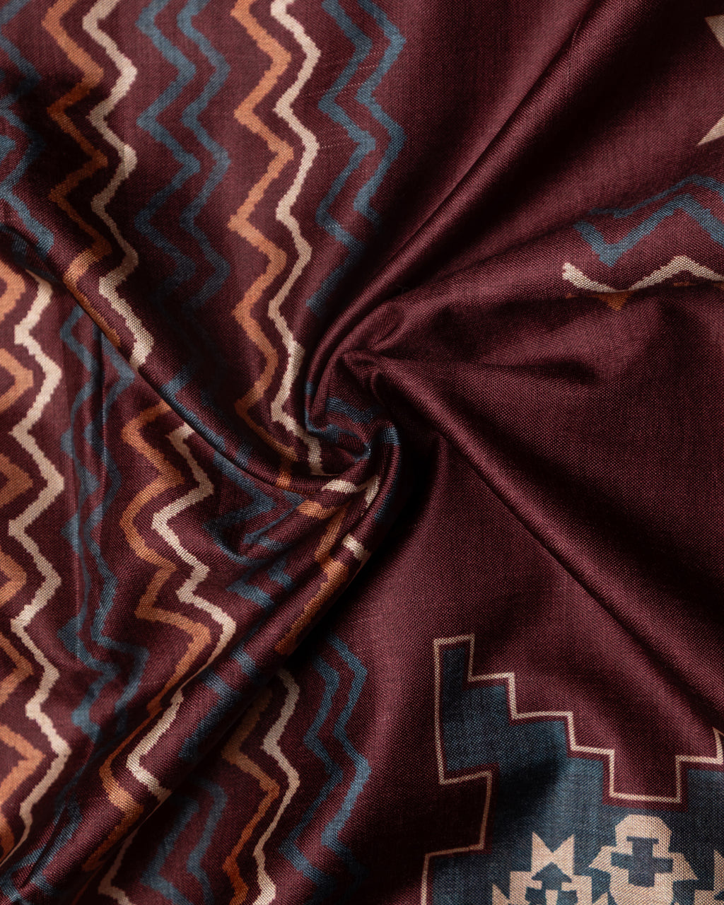 Close-up of the traditional ethnic motifs and textured weave of the premium Brown Cotton-Tissue fabric.