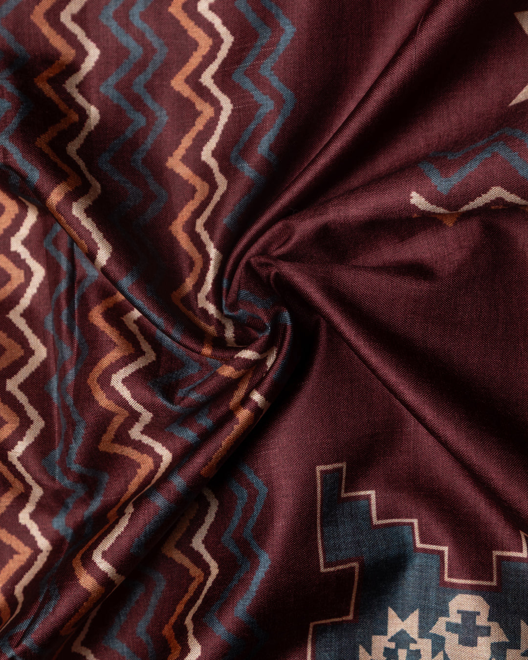 Close-up of the traditional ethnic motifs and textured weave of the premium Brown Cotton-Tissue fabric.