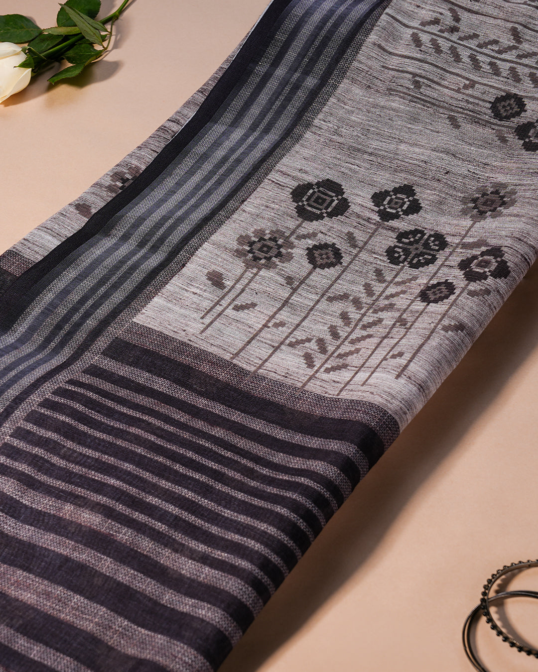 Close-up of the detailed floral-round motifs and striped pallu design on the Grey Cotton Rajathee Saree.