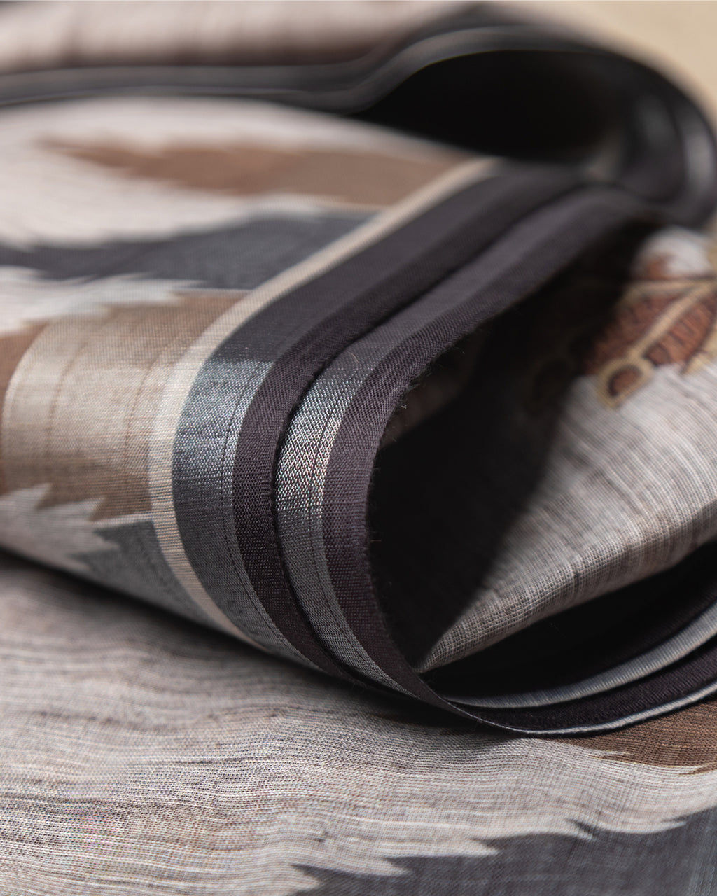 Close-up of the crisp geometric border and striped accents on the Grey Cotton Saree by Rajathee Saree.