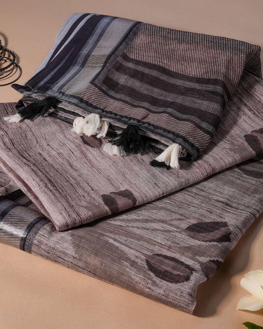 Detailed view of the striped pallu and white tassel accents on the Grey Cotton Saree by Rajathee Saree.