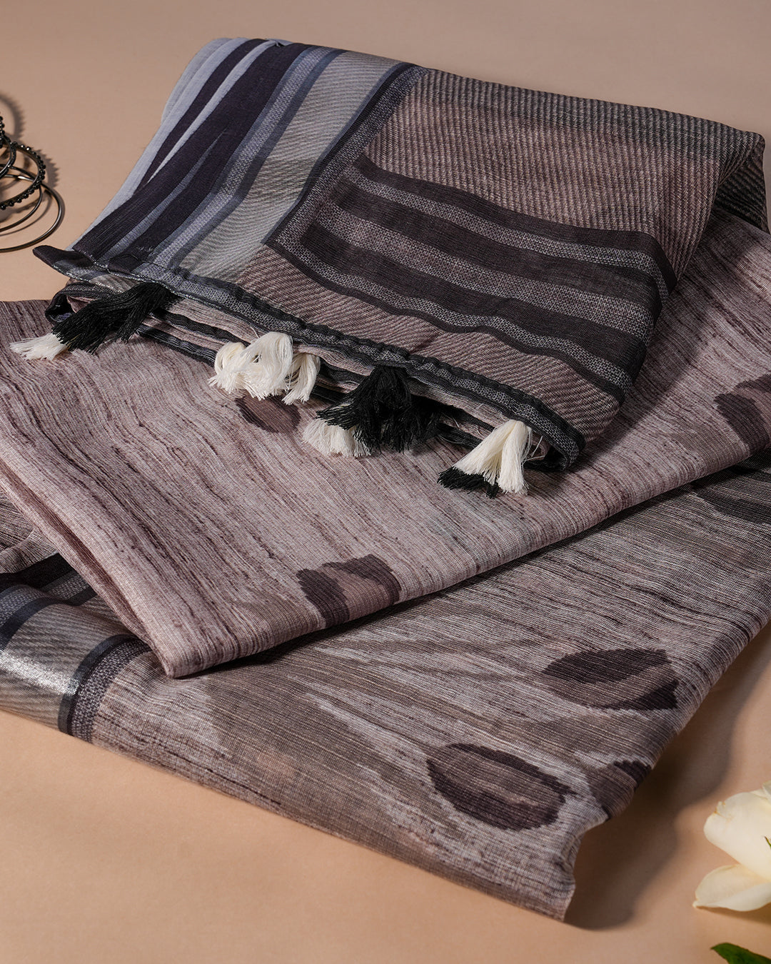 Detailed view of the striped pallu and white tassel accents on the Grey Cotton Saree by Rajathee Saree.