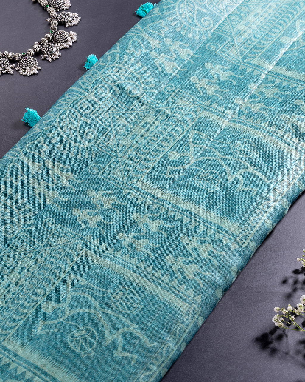 Detailed view of the intricate stone age inspired Warli motifs on the Sea Green Cotton fabric from Rajathee Saree.