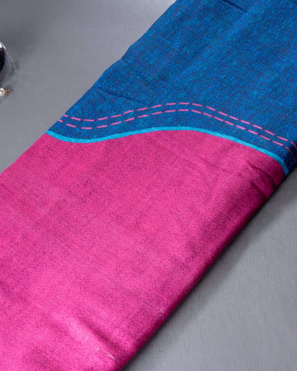 Detailed view of the pink contrast pallu with modern line accents on the Blue Rajathee Saree.