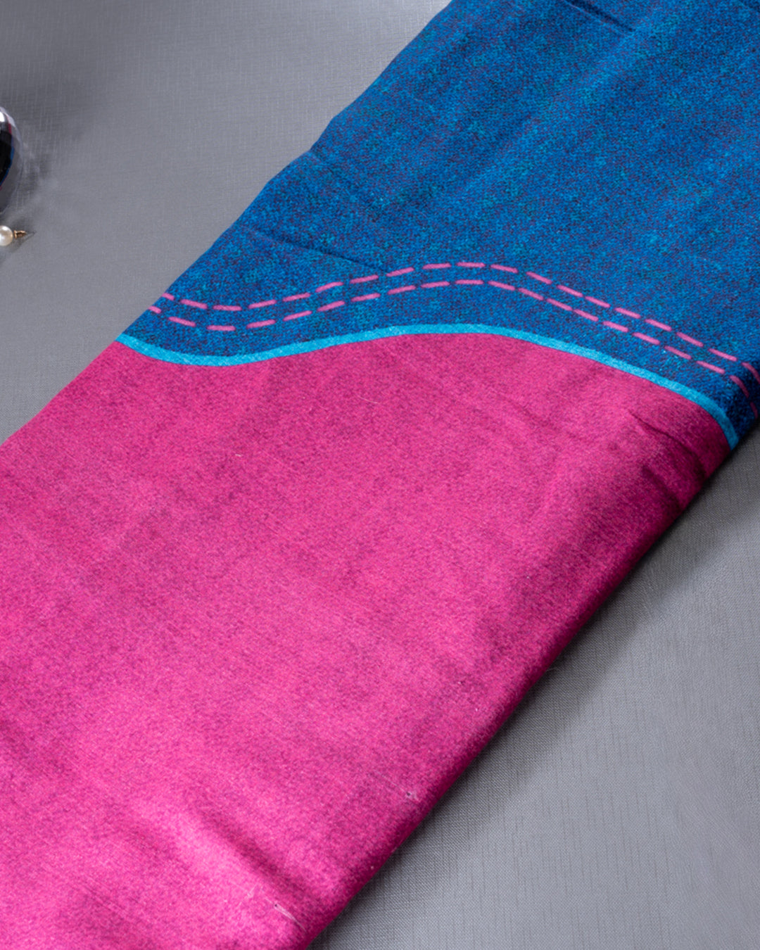 Detailed view of the pink contrast pallu with modern line accents on the Blue Rajathee Saree.