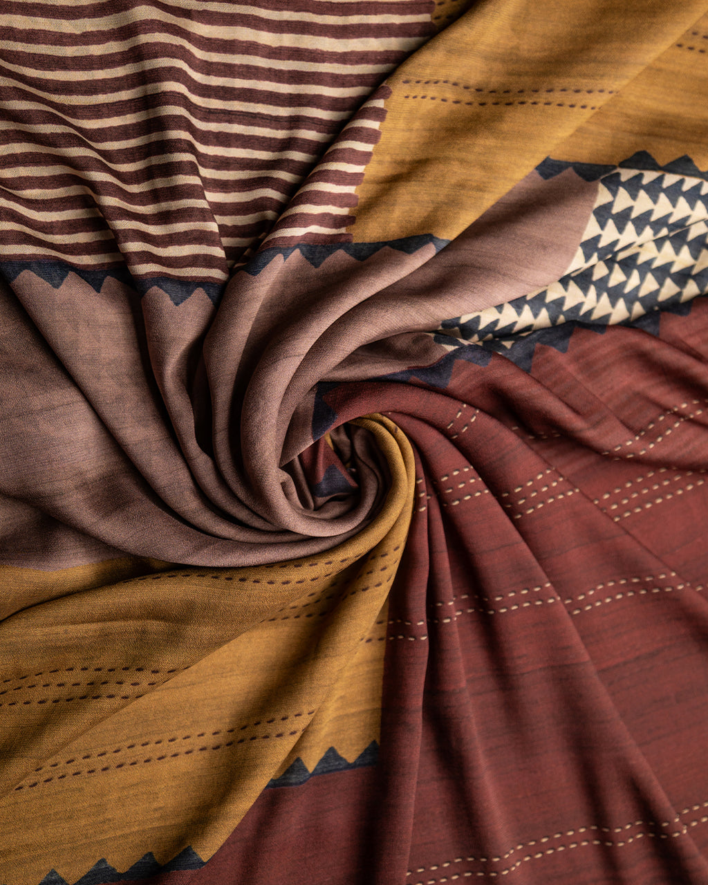 Close-up of the intricate rust and olive geometric prints on the premium, soft Silk Georgette fabric.