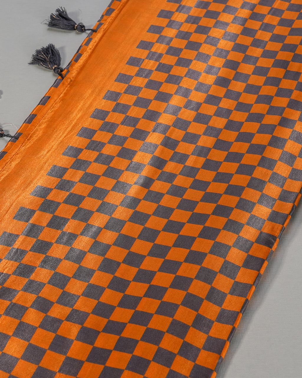 Detailed view of the checkered grid pallu and coordinating black tassels on the Mustard Yellow Rajathee Saree.