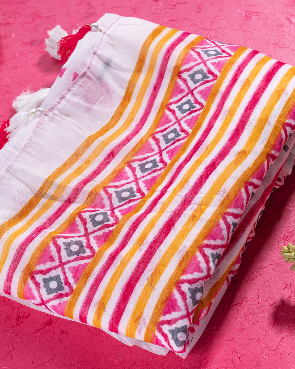 Folded Chandani Pankhuri saree showcasing the high-quality mul cotton fabric and patterned borders.