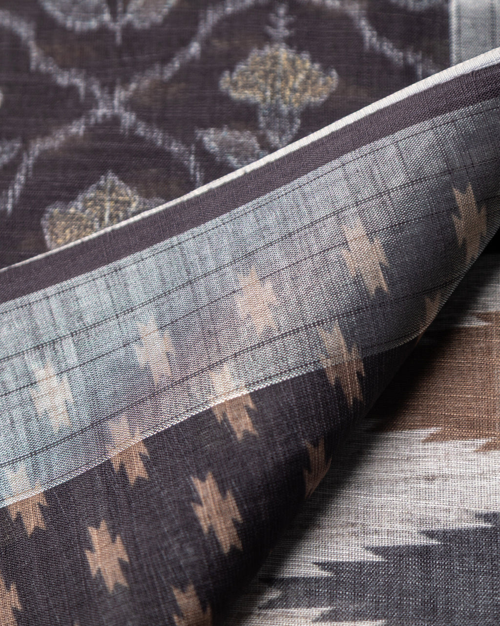 Detailed view of the peacock motifs and structured cotton fabric texture of the Grey Rajathee Saree.