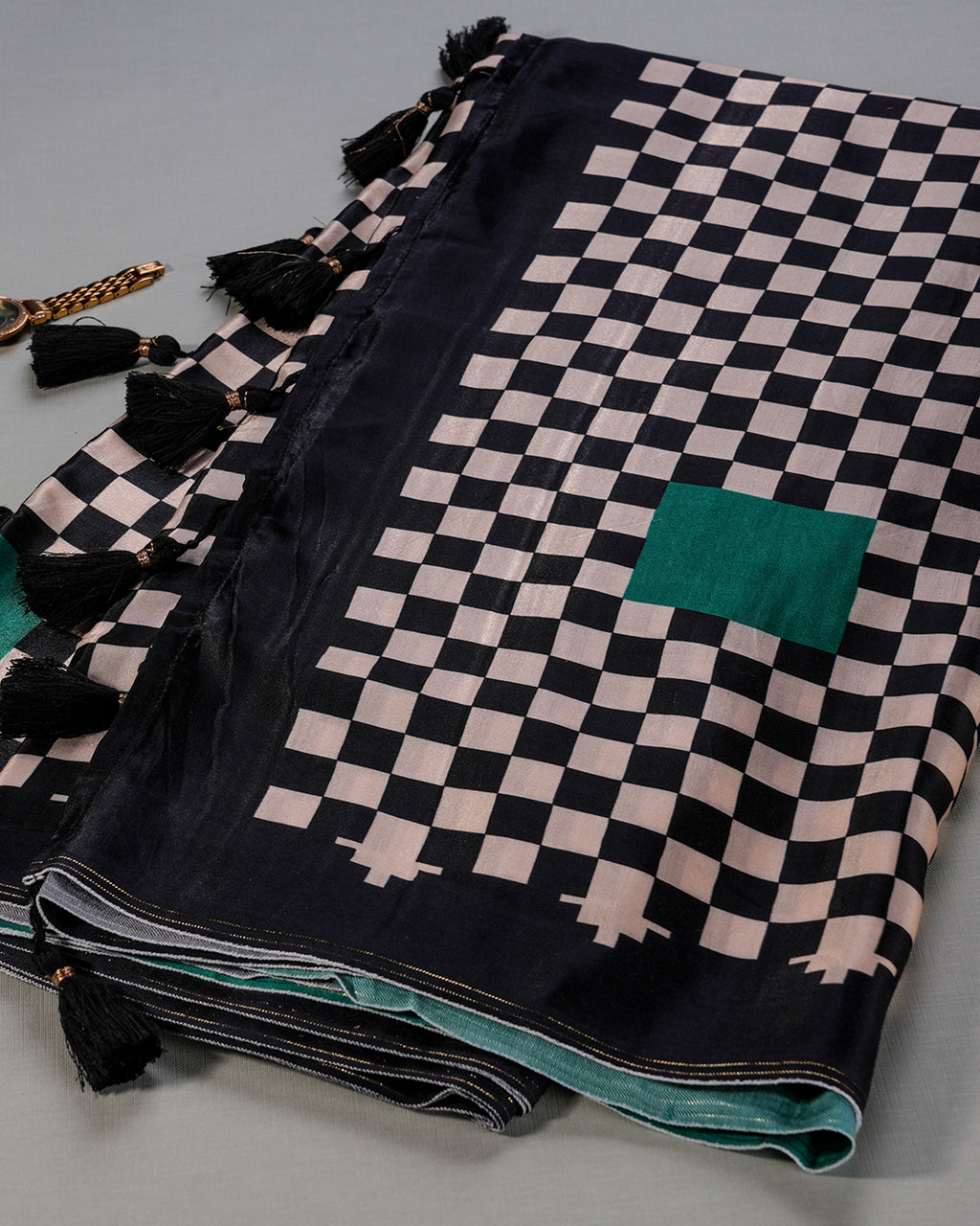 Showcase of the modern geometric print and deep emerald green accents on the Rajathee Saree Modal Satin.