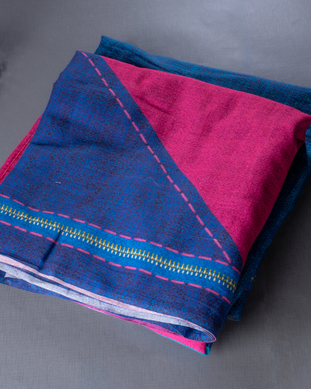 Folded Blue and Pink Mul Cotton Saree from Rajathee Saree showcasing the soft, natural fabric and color contrast.