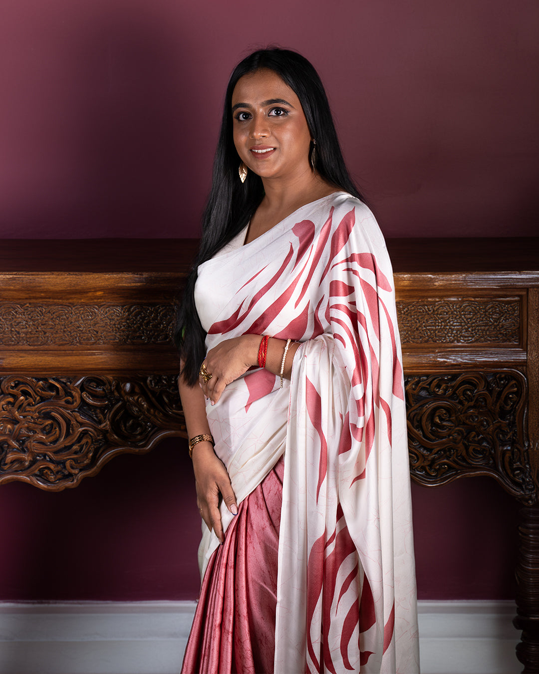 A Gulabdaani Saree in a vibrant floral print with a contrasting border, draped elegantly.