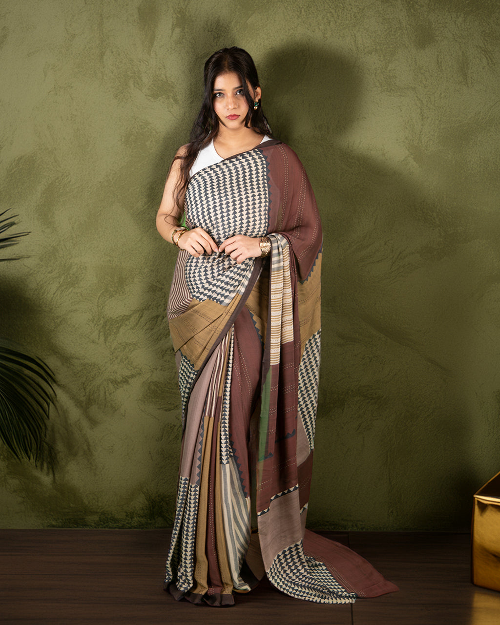 Rajathee Saree Olive and Rust Silk Georgette Saree featuring a mix of geometric prints and a fluid, lightweight drape.