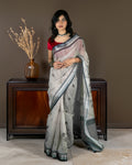 Rajathee Saree Grey Cotton Saree featuring subtle round motifs and a sophisticated striped border.