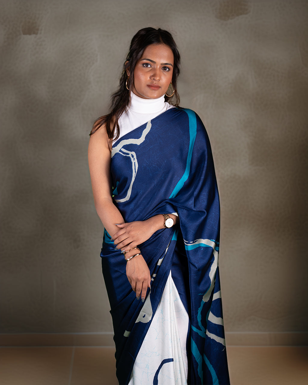 A model showcasing the deep blue variant of the lightweight crepe saree with a modern abstract brush spread print.