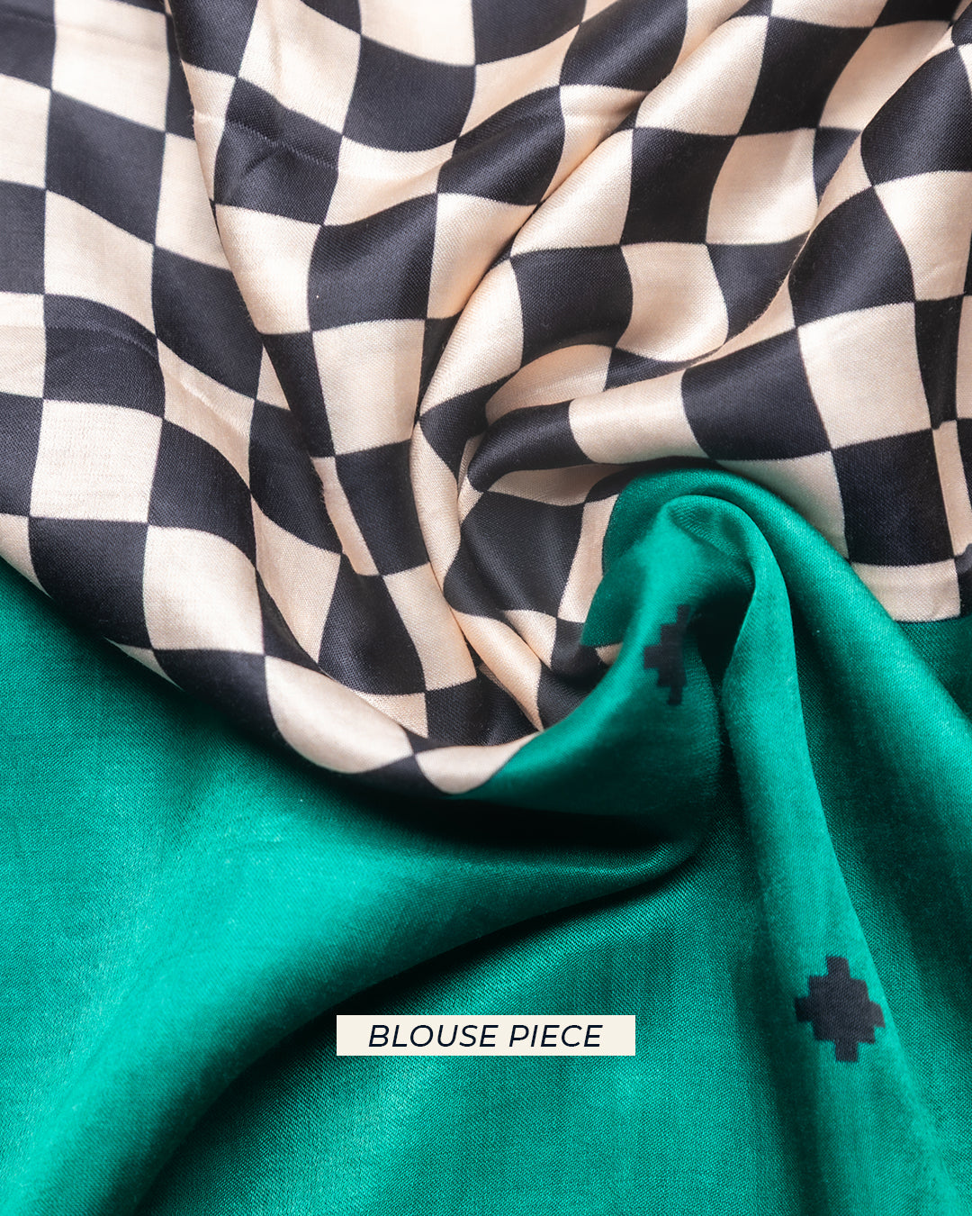 Matching solid emerald green unstitched blouse piece fabric with a subtle checkered motif for the Rajathee Saree collection.