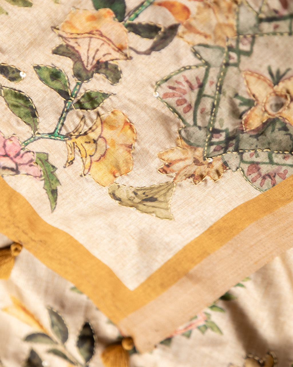 Close-up of the breathable Mustard Beige Cotton-Tissue fabric with intricate botanical border detailing.