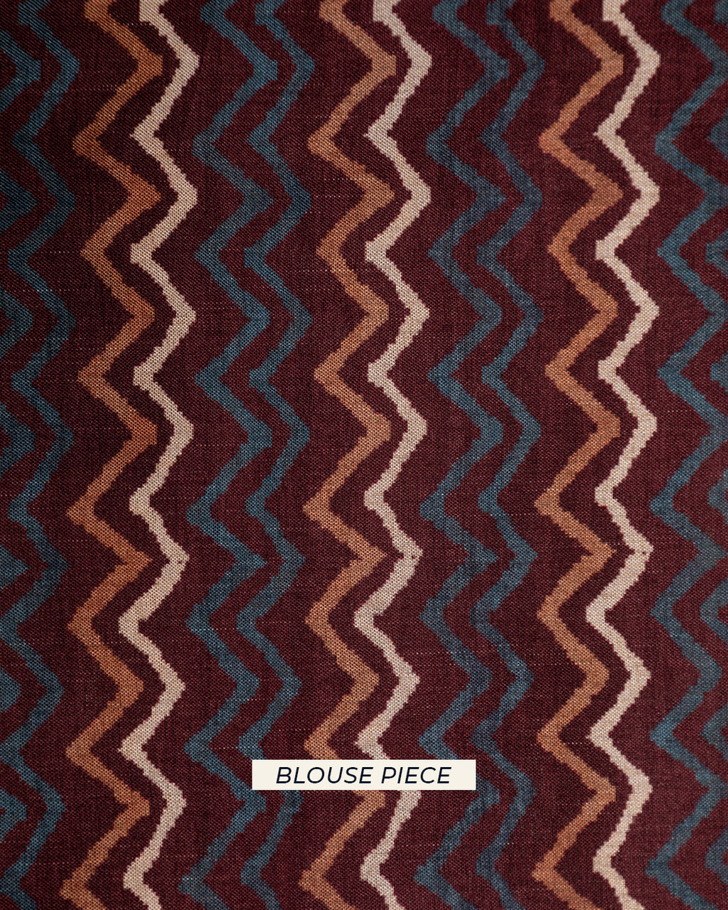 Matching brown unstitched blouse piece with a modern zig-zag chevron pattern for the Rajathee Saree collection.