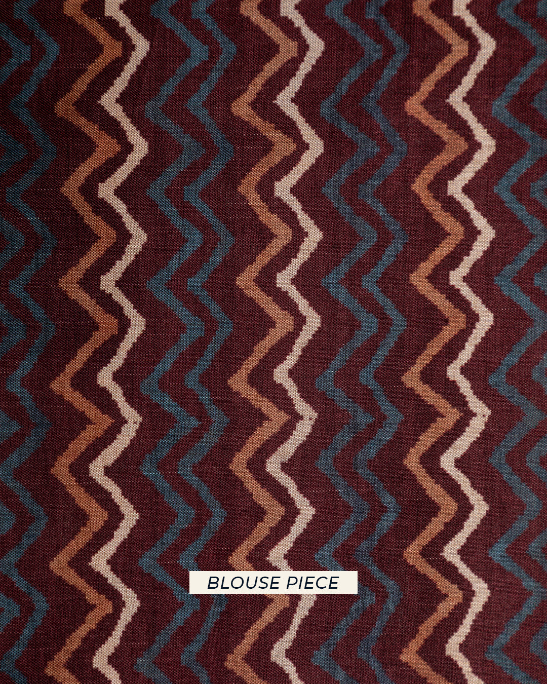 Matching brown unstitched blouse piece with a modern zig-zag chevron pattern for the Rajathee Saree collection.