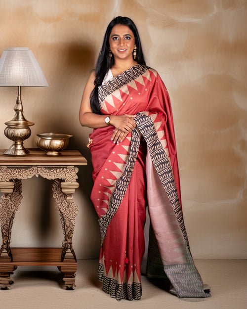 Rajathee Saree Red Raw Silk and Cotton Blend Saree featuring handcrafted floral embellishments and a traditional temple border.