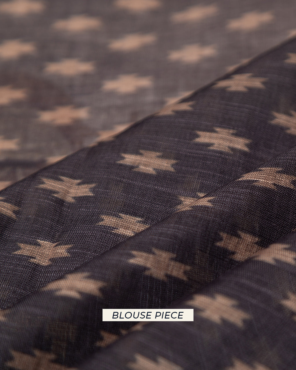 Matching dark grey unstitched blouse piece fabric with small geometric star motifs for the Rajathee Saree collection.