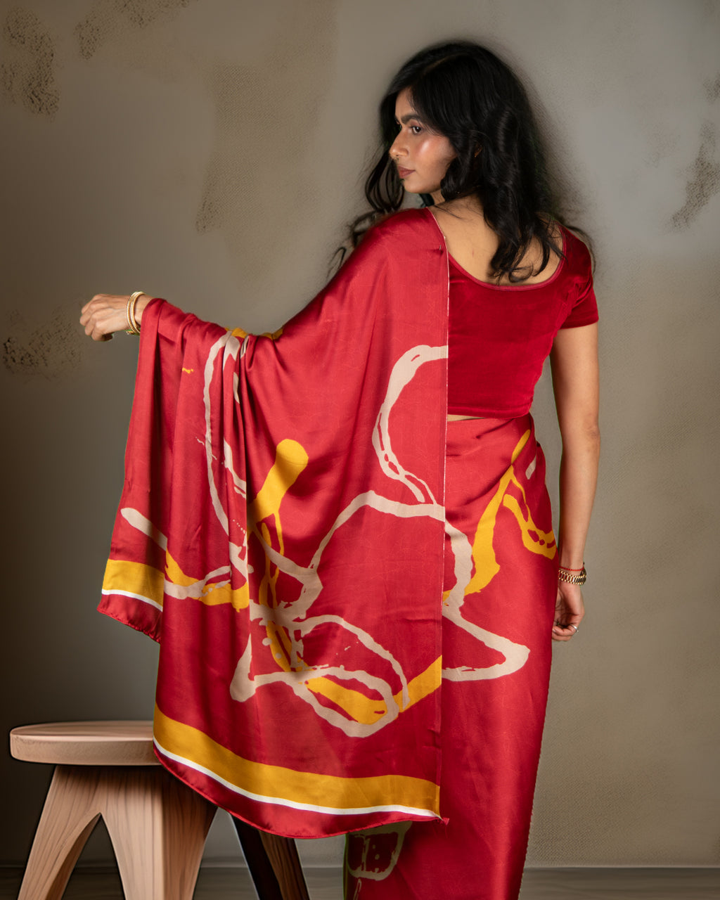 Back view of the vibrant red abstract print crepe saree, demonstrating the lightweight and breathable nature of the fabric.