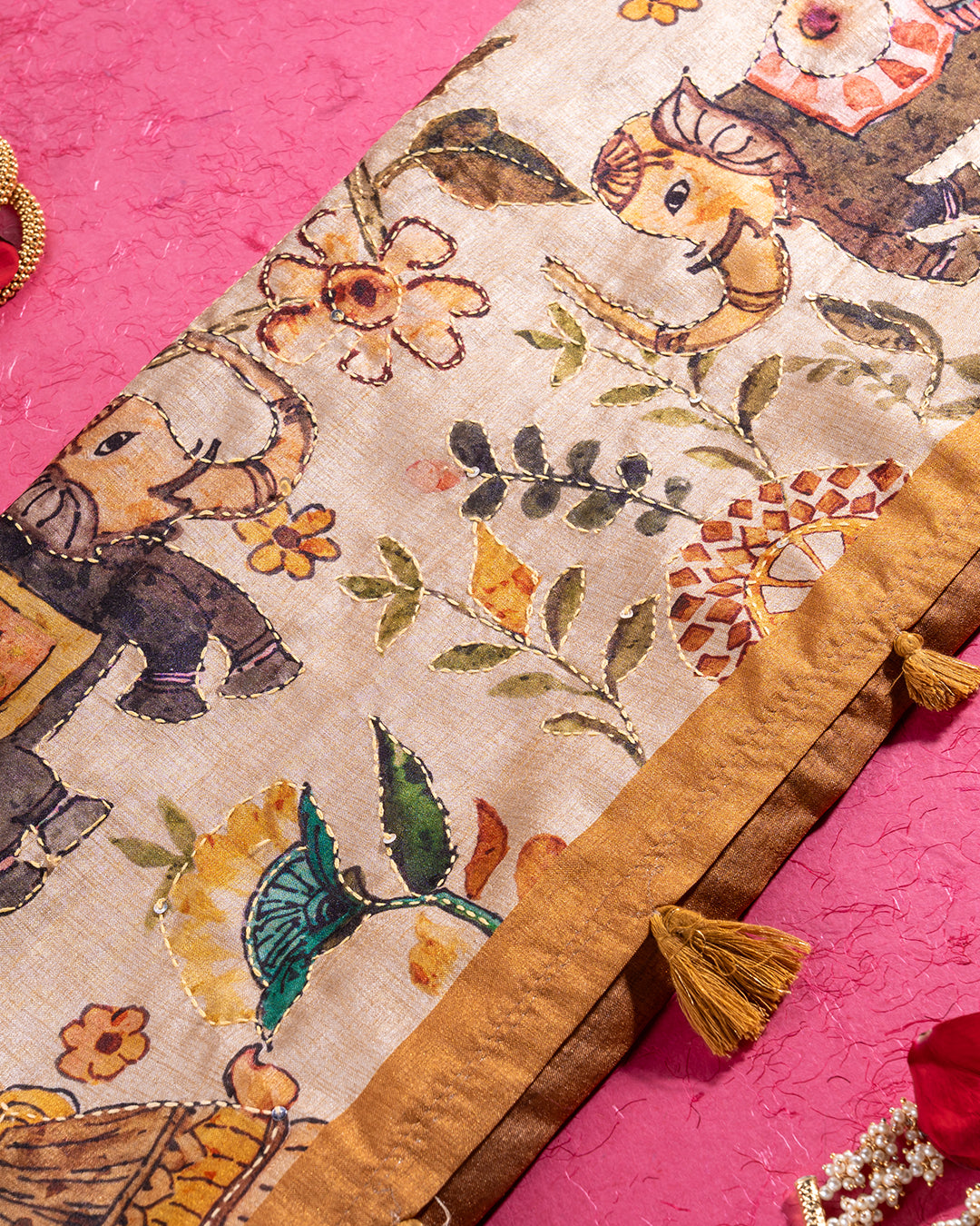 Detailed view of the botanical narrative motifs and decorative tassels on the Rajathee Saree Mustard Beige pallu.
