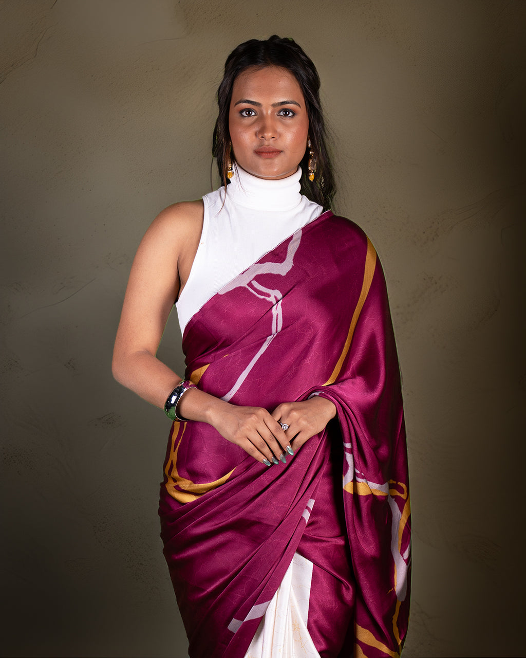A model draped in the rich purple version of the contemporary abstract print saree, highlighting its elegant and flowy drape.