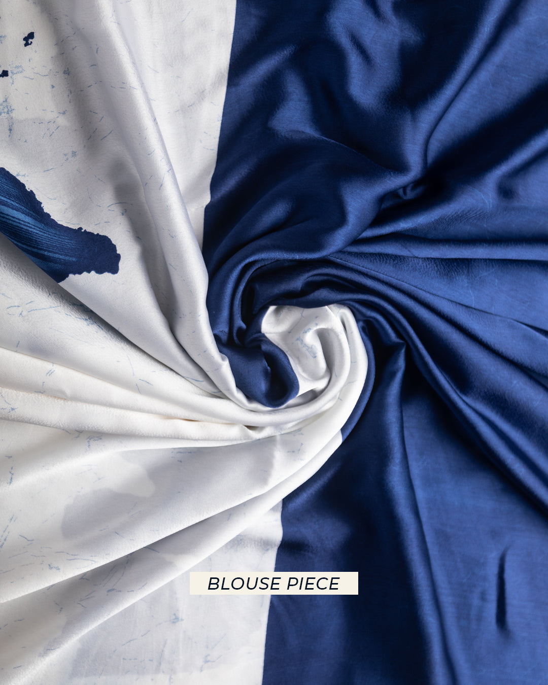 Close-up detail of the bicolour blue and white crepe fabric provided as the matching blouse piece.