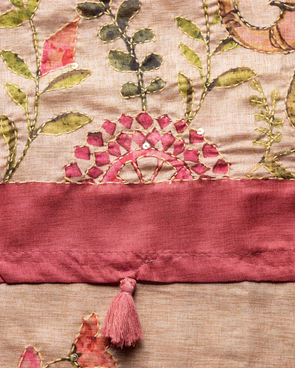 Close-up of the elegant pink tassels and detailed border on the Blush Pink Cotton Tissue Saree.