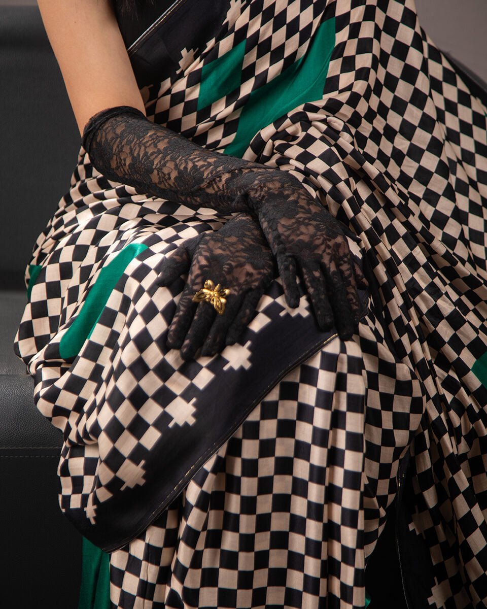 Close-up of the sophisticated checkered geometric grid and silky texture of the Rajathee Saree Modal Satin fabric.
