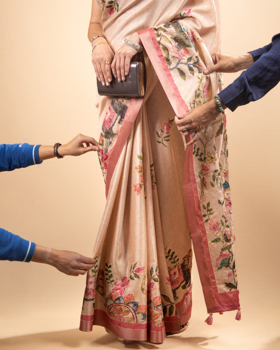 Close-up of the pleated drape of the Blush Pink Cotton Tissue Saree highlighting the fabric's soft sheen and texture.