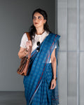 Rajathee Saree Blue Mul Cotton Saree featuring a subtle check pattern and vibrant red contrast thread detailing.
