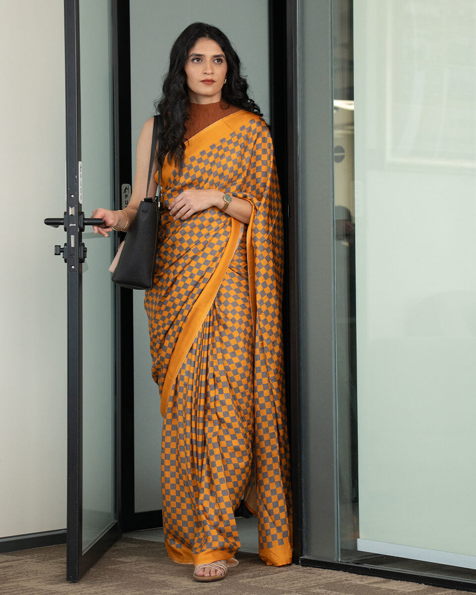 Rajathee Saree Mustard Yellow Modal Satin Saree featuring a modern checkered geometric grid and silky glossy drape.